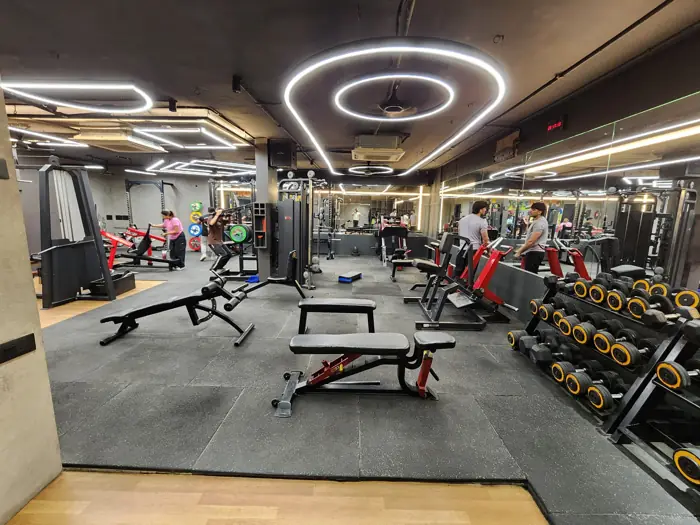 Dumbbell rack and benches under ring lights
