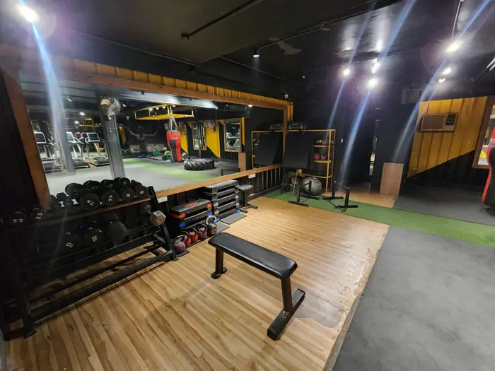 Dumbbells and bench on the wooden platform
