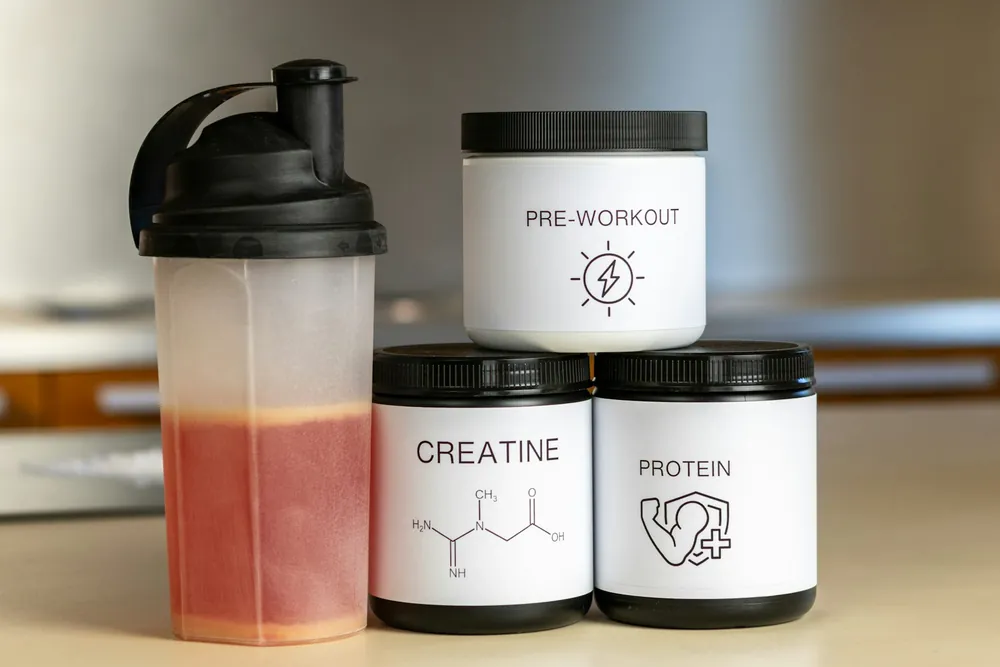 Shaker with protein, creatine and pre-workout tubs